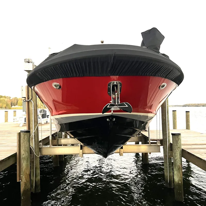 Slide: The Image of 2017 Sea Ray 350 SLX boat docked, front view, red and black hull. - 38