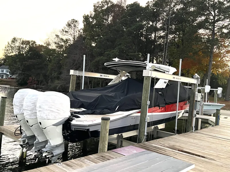 Slide: The Image of 2017 Sea Ray 350 SLX boat docked with protective cover, dual engines visible. - 5