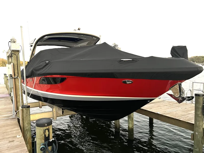 Slide: The Image of 2017 Sea Ray 350 SLX boat with black cover on dock. - 6