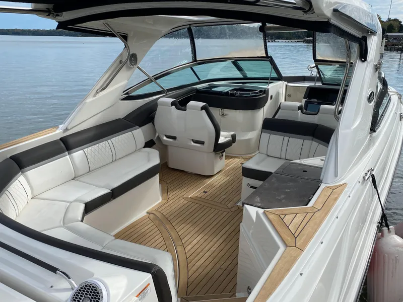 Slide: The Image of 2017 Sea Ray 350 SLX boat with spacious seating and elegant interior on calm water. - 7