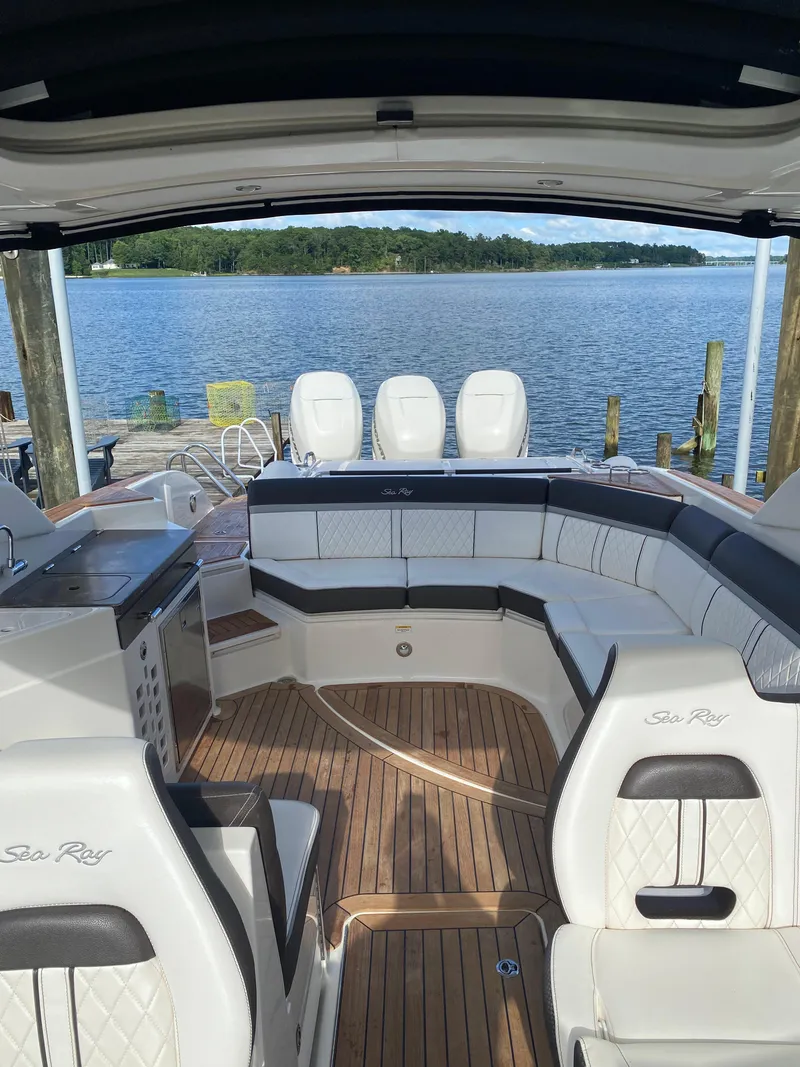 Slide: The Image of 2017 Sea Ray 350 SLX boat interior with luxurious seating and scenic water view. - 8