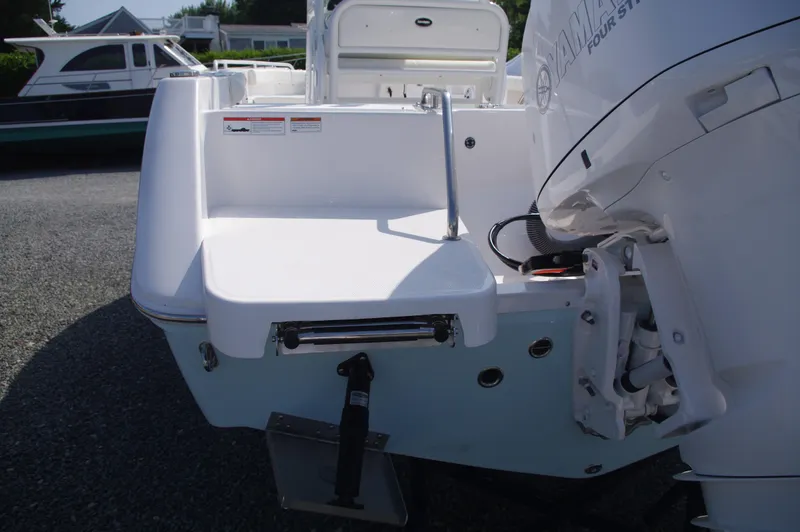 Slide: The Image of 2022 Everglades 235 Center Console boat with outboard motor and swim platform. - 2