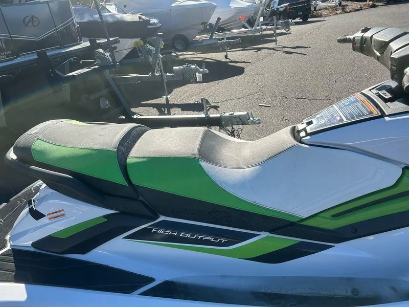 Slide: The Image of 2020 Yamaha WaveRunner FX HO jet ski with green and white seat, parked outdoors. - 5