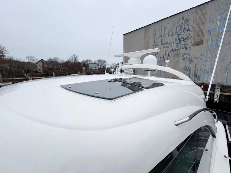 Slide: The Image of 2006 Sea Ray 48 Sundancer yacht with sleek white exterior and rooftop features. - 12