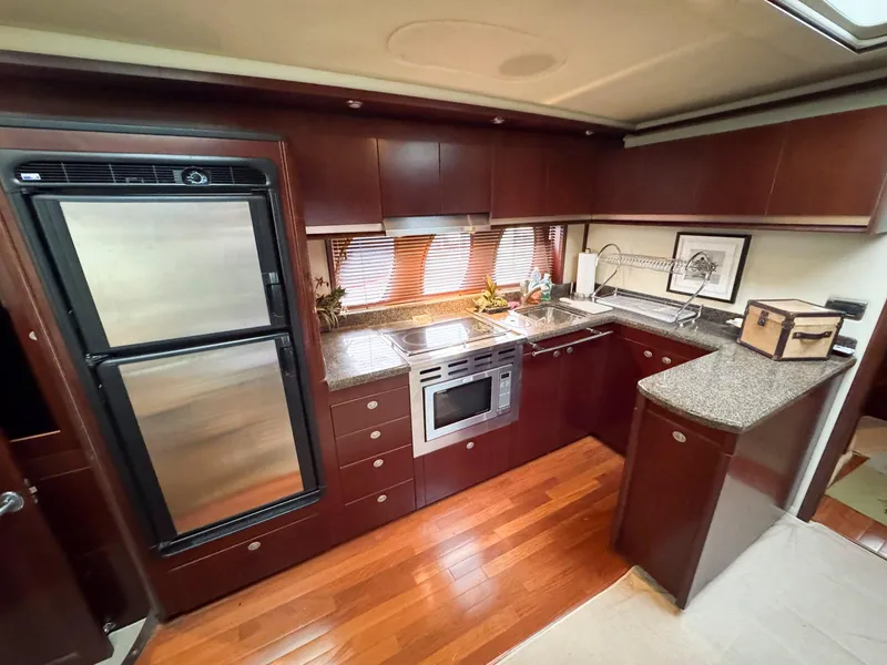 Slide: The Image of Luxurious kitchen interior of 2006 Sea Ray 48 Sundancer yacht with modern appliances. - 17