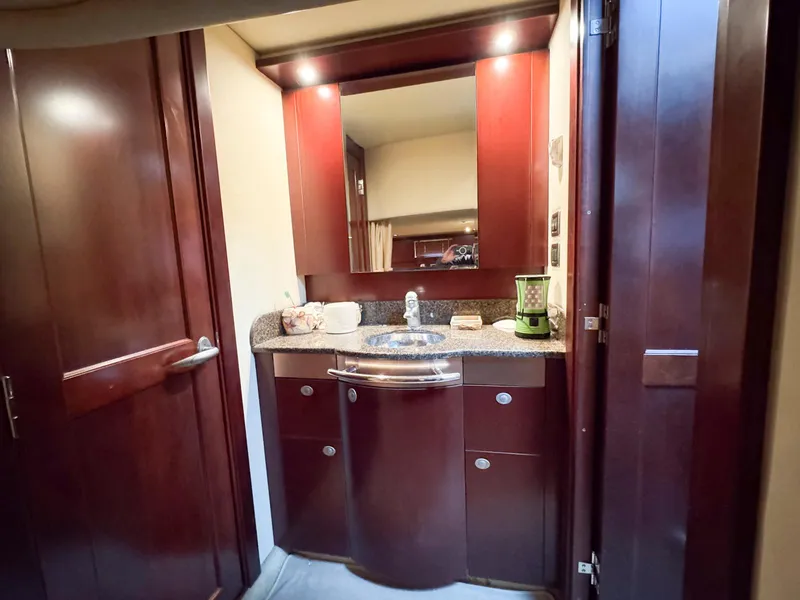 Slide: The Image of Luxurious 2006 Sea Ray 48 Sundancer bathroom with elegant wood cabinetry and modern fixtures. - 21