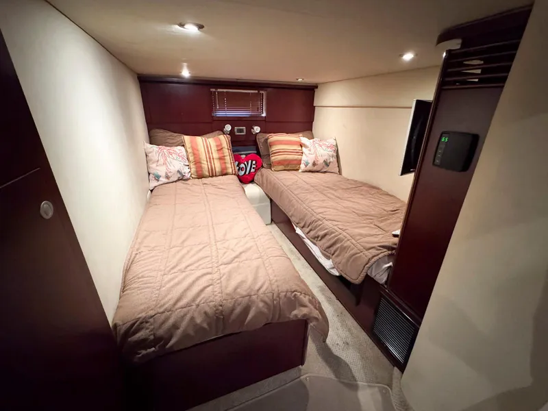 Slide: The Image of Interior cabin of 2006 Sea Ray 48 Sundancer with twin beds and cozy decor. - 24