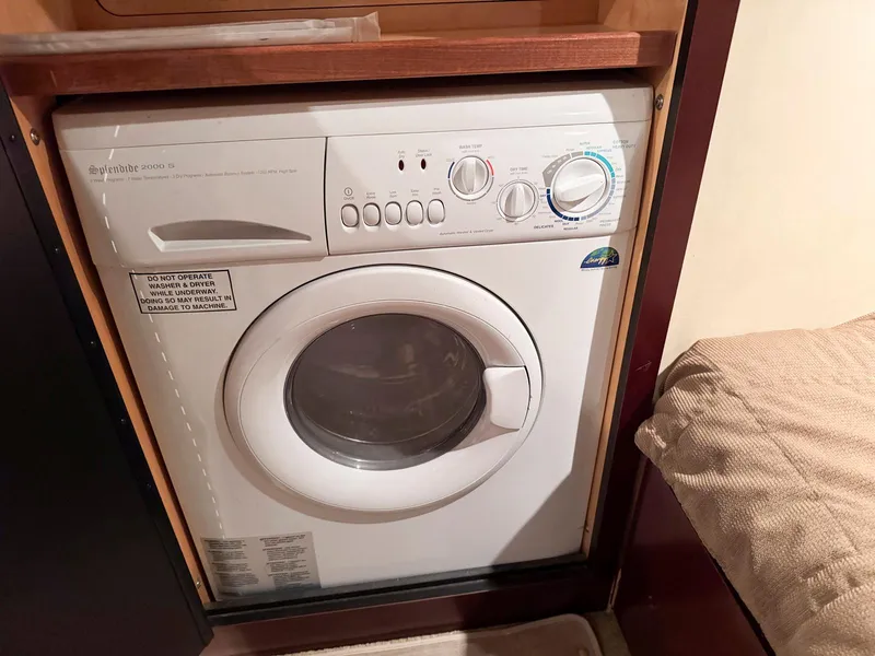 Slide: The Image of Compact washing machine inside 2006 Sea Ray 48 Sundancer yacht cabin. - 25