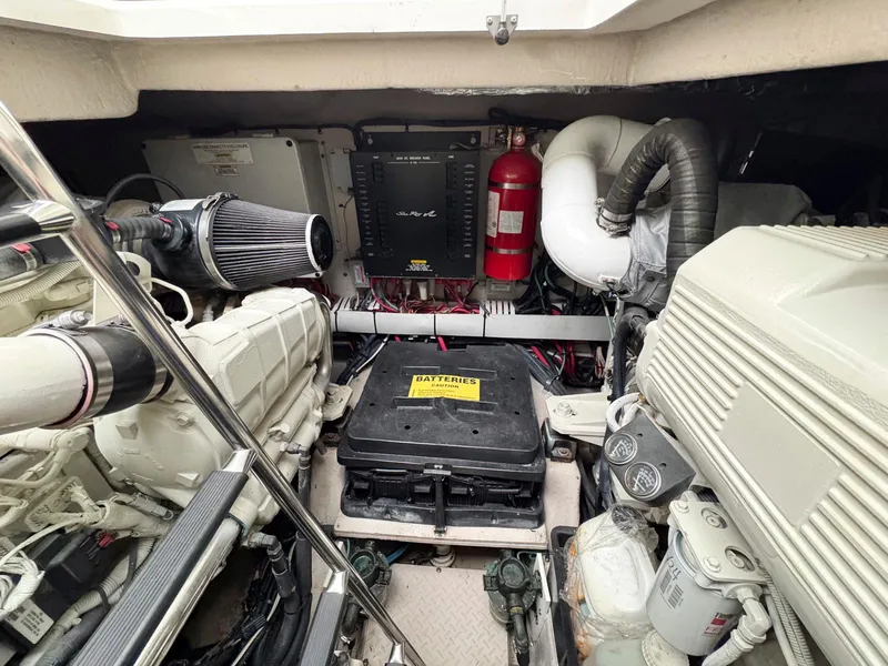 Slide: The Image of Engine room of 2006 Sea Ray 48 Sundancer yacht, featuring mechanical components and fire extinguisher. - 28
