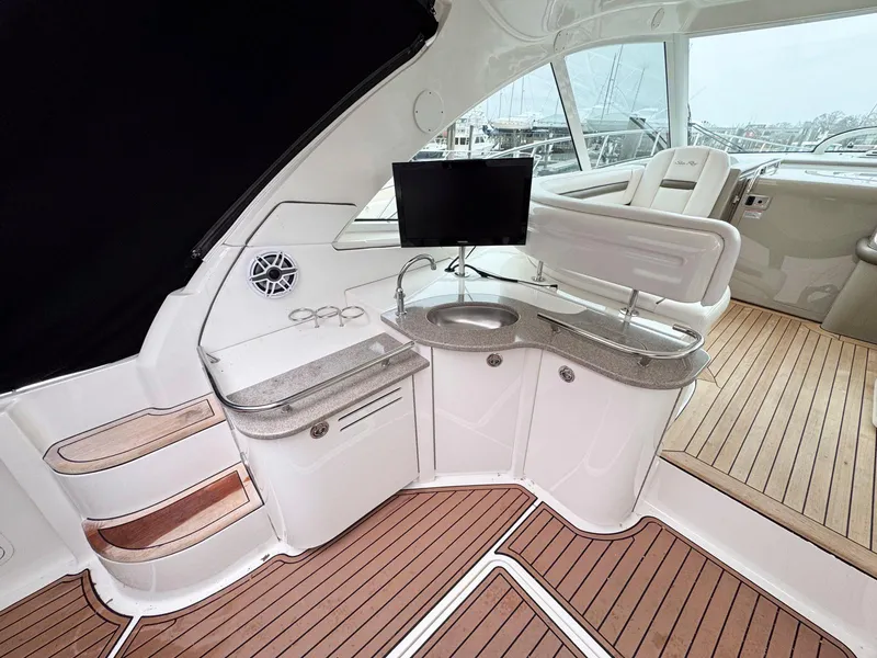 Slide: The Image of Luxurious 2006 Sea Ray 48 Sundancer yacht interior with sleek kitchenette and modern amenities. - 7