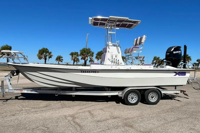 Slide: The Image of 2018 Shallow Sport 25 X3 boat on trailer, clear sky background. - 0