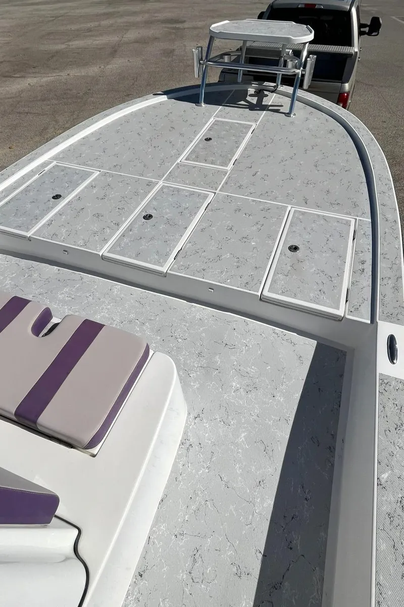 Slide: The Image of 2018 Shallow Sport 25 X3 boat deck with seating and storage compartments. - 10