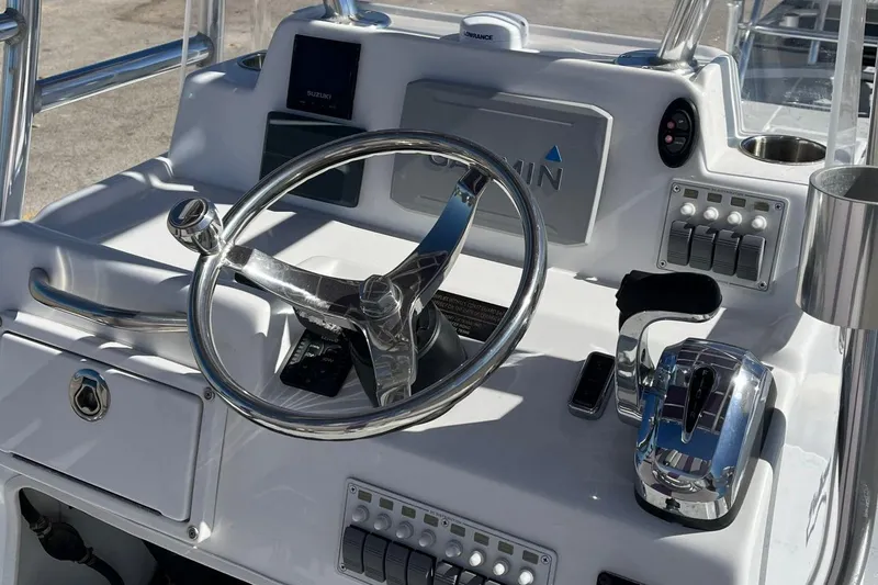 Slide: The Image of 2018 Shallow Sport 25 X3 boat console with steering wheel and controls. - 12