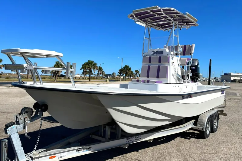 Slide: The Image of 2018 Shallow Sport 25 X3 boat on trailer, clear sky background. - 2