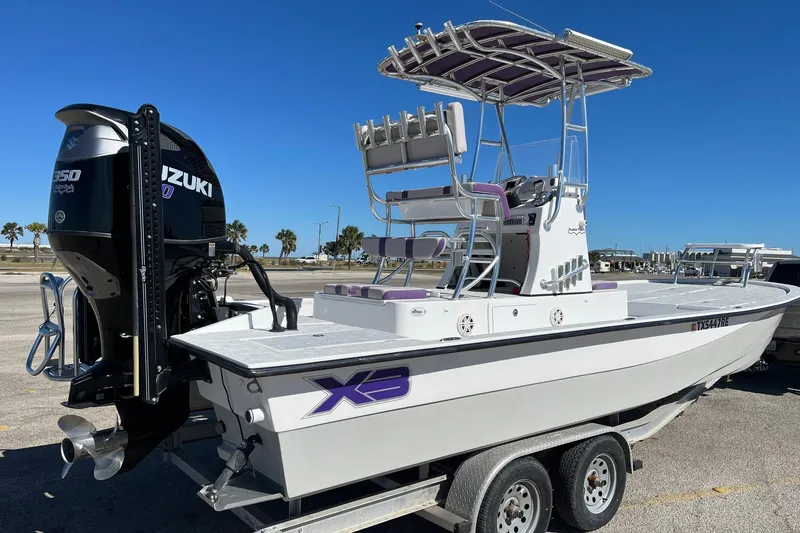 Slide: The Image of 2018 Shallow Sport 25 X3 boat on trailer with Suzuki outboard motor. - 4