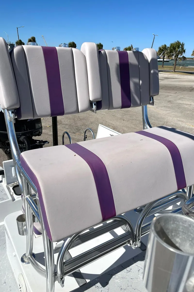 Slide: The Image of Shallow Sport 25 X3 2018 boat seats with purple and white upholstery. - 6