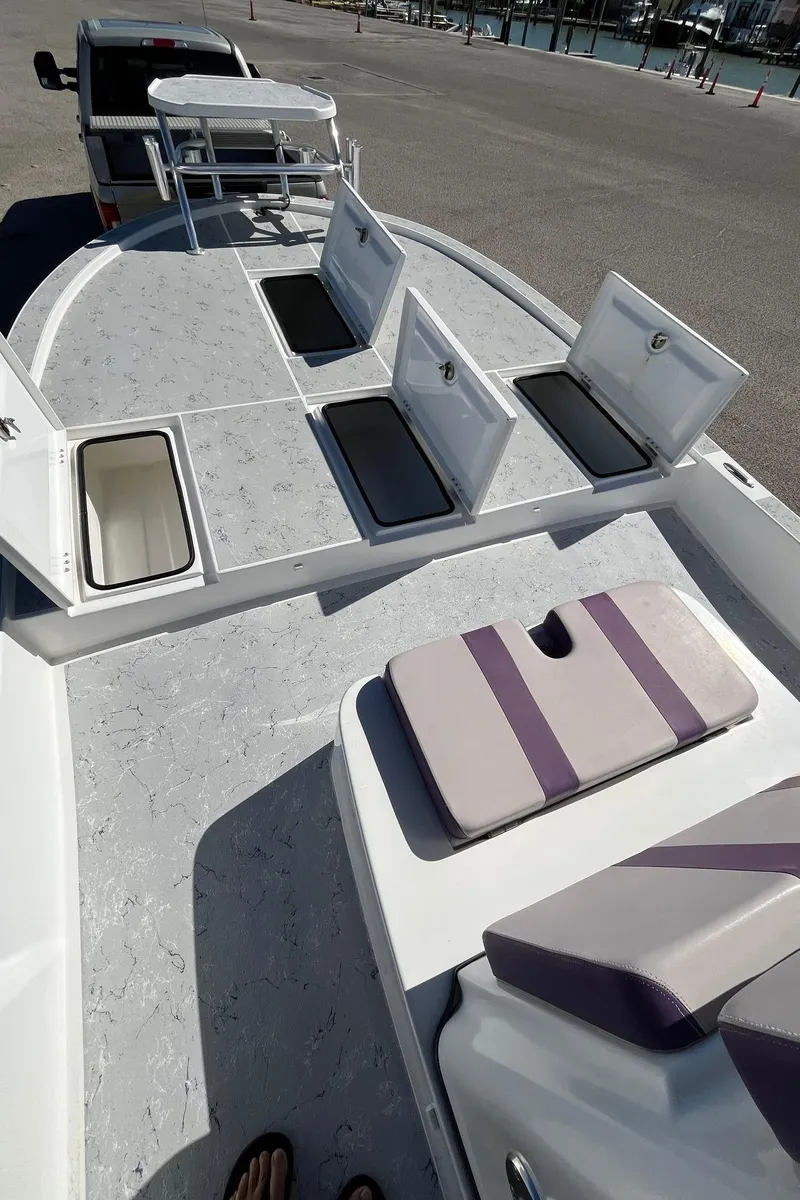 Slide: The Image of 2018 Shallow Sport 25 X3 boat with open storage compartments and seating. - 7