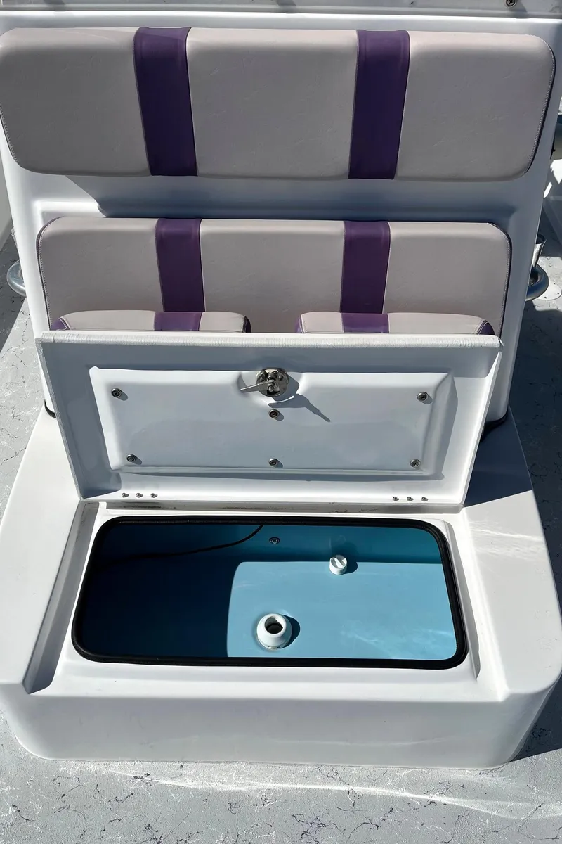 Slide: The Image of 2018 Shallow Sport 25 X3 boat seat with storage compartment open. - 8