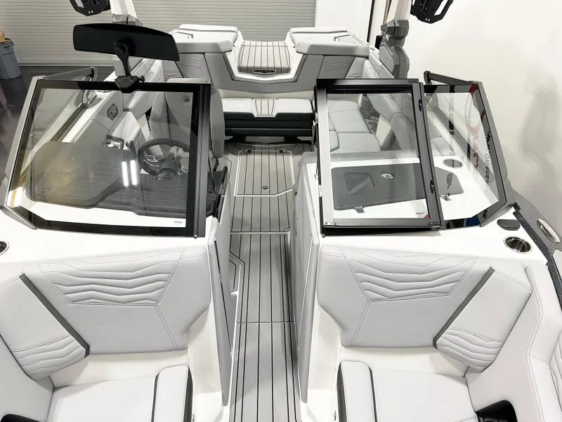 Slide: The Image of 2025 Nautique Super Air Nautique G21 interior with sleek white seating and modern design. - 4