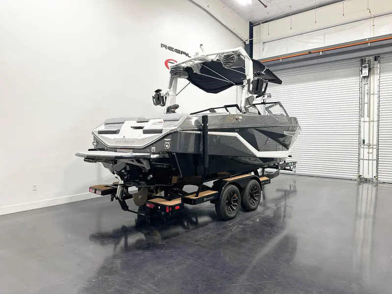 Slide: The Image of 2025 Nautique Super Air Nautique G21 boat on trailer in showroom. - 5