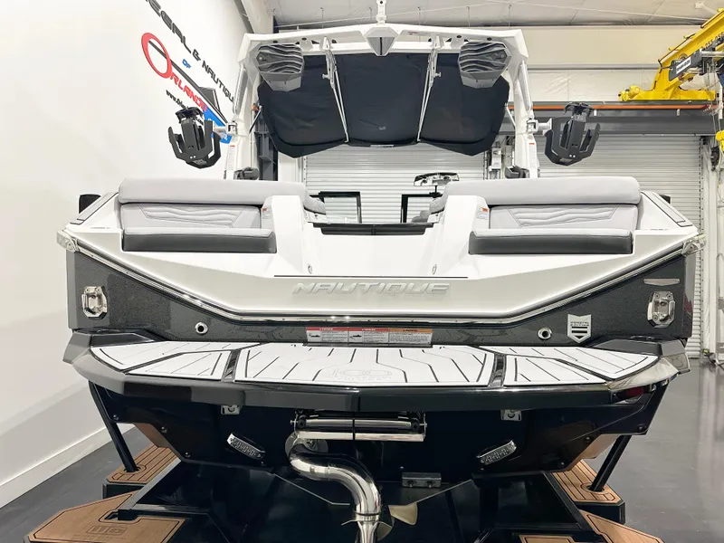 Slide: The Image of 2025 Nautique Super Air Nautique G21 boat in showroom, rear view. - 6