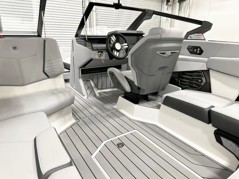 Slide: The Image of 2025 Nautique Super Air Nautique G21 interior with sleek gray seating and modern dashboard. - 8