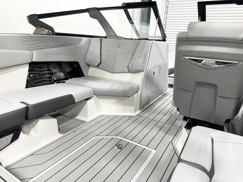 Slide: The Image of 2025 Nautique Super Air Nautique G21 interior with sleek gray seating and modern design. - 9