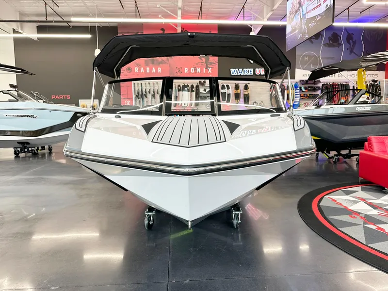 Slide: The Image of 2025 Nautique Ski boat displayed in showroom, front view. - 4