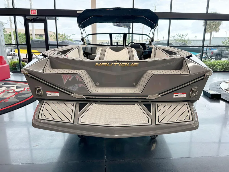 Slide: The Image of 2025 Nautique Ski boat displayed in showroom, rear view. - 5