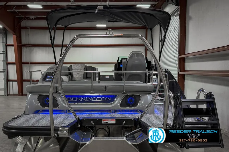 Slide: The Image of 2025 Bennington 23 RSB pontoon boat with sleek design and modern features in a showroom. - 12