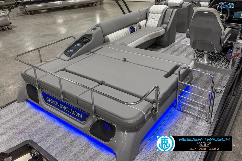Slide: The Image of 2025 Bennington 23 RSB boat interior with gray seating and blue LED lighting. - 16
