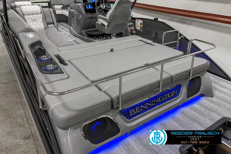 Slide: The Image of 2025 Bennington 23 RSB boat interior with plush seating and blue LED lighting. - 17