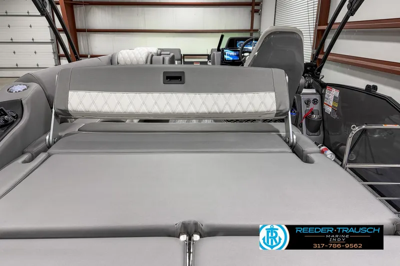 Slide: The Image of 2025 Bennington 23 RSB boat interior with gray seating in a showroom. - 21
