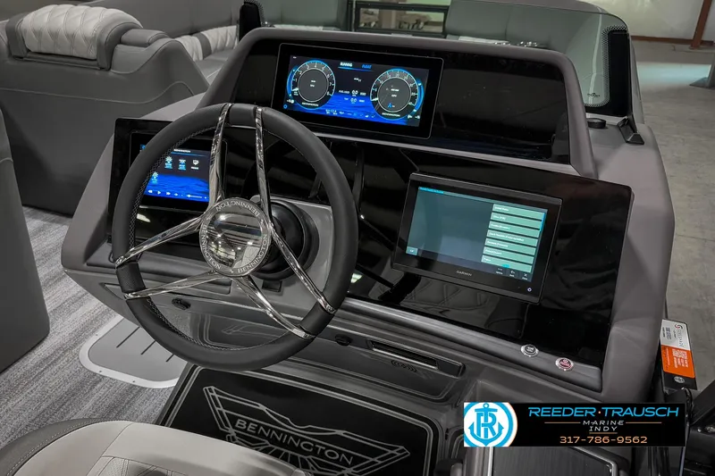 Slide: The Image of 2025 Bennington 23 RSB boat dashboard with modern digital displays and steering wheel. - 37