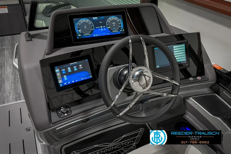 Slide: The Image of 2025 Bennington 23 RSB boat dashboard with modern digital displays and steering wheel. - 38
