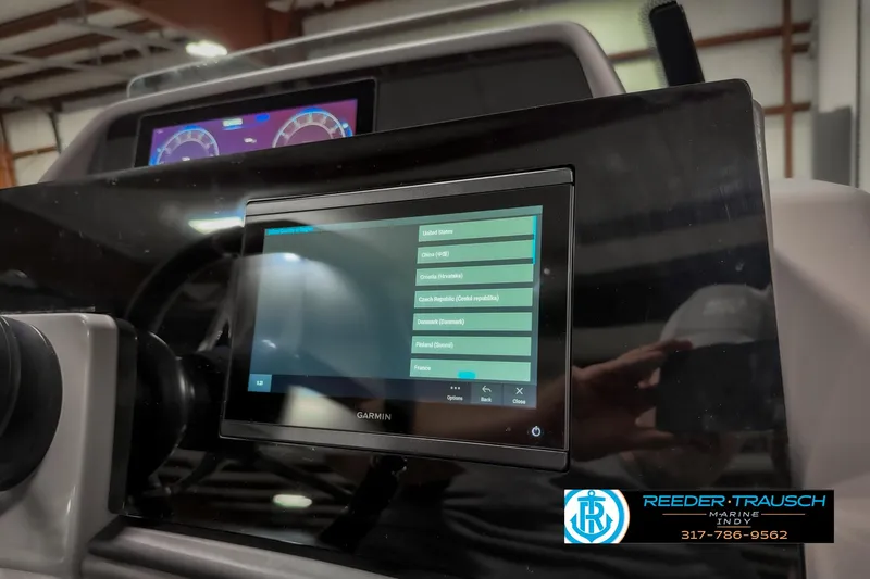 Slide: The Image of 2025 Bennington 23 RSB boat dashboard with Garmin display and controls. - 43