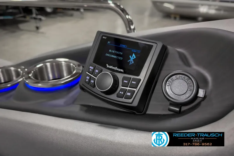 Slide: The Image of 2025 Bennington 23 RSB boat dashboard with Bluetooth stereo system and cup holders. - 48