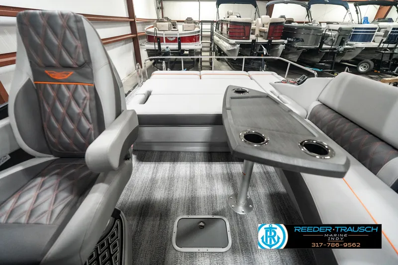 Slide: The Image of 2025 Bennington 23 RSB boat interior with luxury seating and table, showcased at Reeder-Trausch Marine. - 14