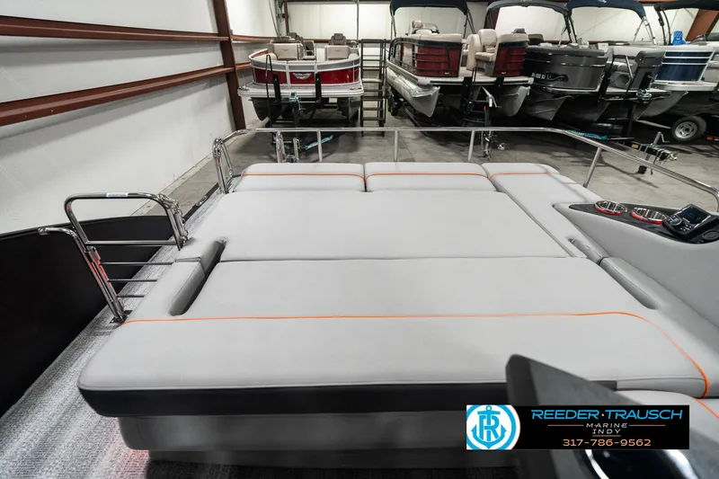 Slide: The Image of 2025 Bennington 23 RSB boat interior with spacious seating in showroom. - 15