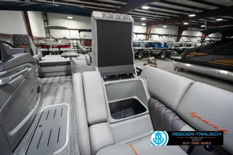 Slide: The Image of 2025 Bennington 23 RSB boat interior with storage compartment, displayed in a showroom. - 22