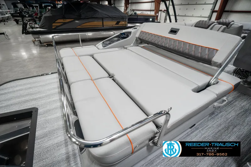 Slide: The Image of 2025 Bennington 23 RSB boat interior with luxurious seating in a showroom. - 31