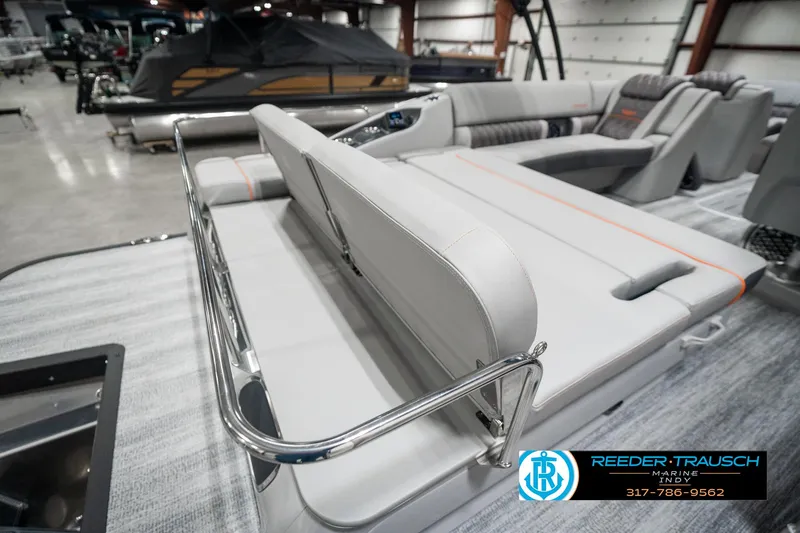 Slide: The Image of 2025 Bennington 23 RSB boat interior with luxurious seating in a showroom. - 32