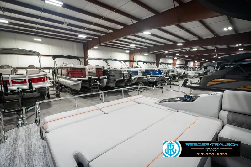 Slide: The Image of Indoor showroom displaying 2025 Bennington 23 RSB boats in a well-lit warehouse. - 33