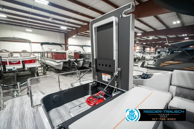Slide: The Image of 2025 Bennington 23 RSB boat interior in showroom, featuring seating and storage. - 34