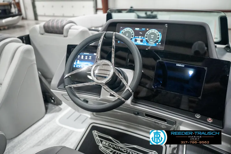 Slide: The Image of 2025 Bennington 23 RSB boat dashboard with modern steering and digital displays. - 35