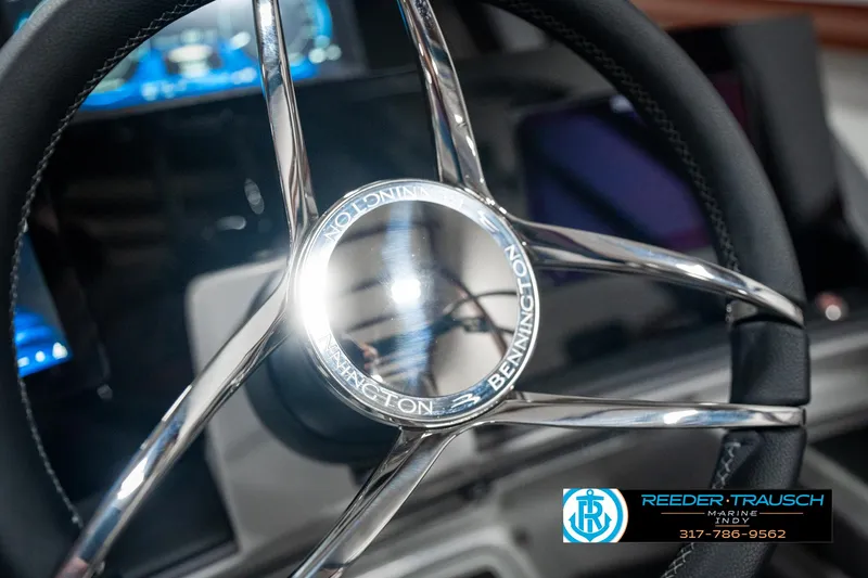 Slide: The Image of 2025 Bennington 23 RSB steering wheel with chrome accents and Reeder-Trausch Marine logo. - 37