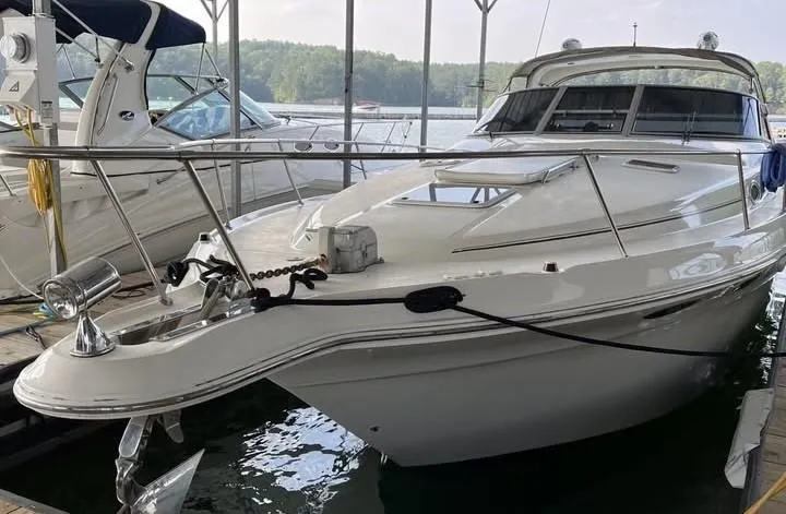 The Image of 1996 Sea Ray 330 Sundancer docked at marina, sleek white design. - 0