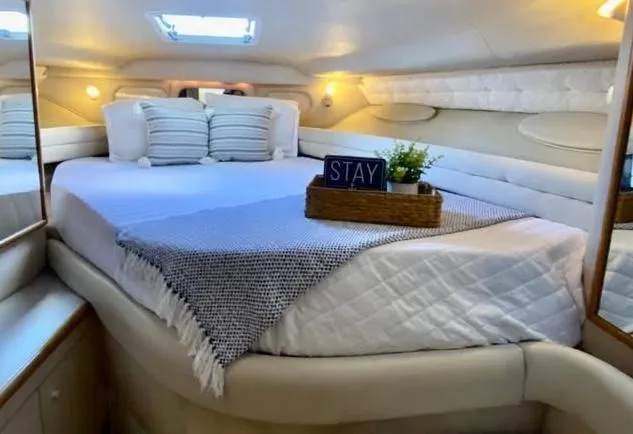 Slide: The Image of Cozy cabin interior of 1996 Sea Ray 330 Sundancer with plush bedding and decor. - 3