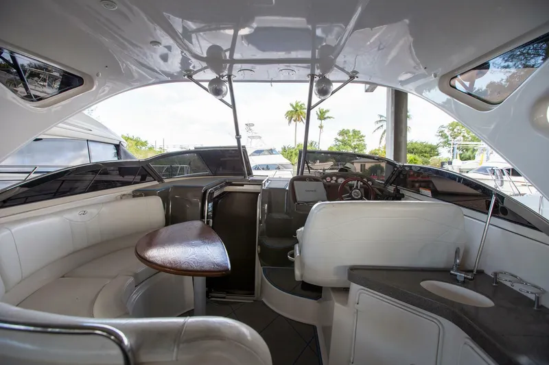 Slide: The Image of Interior of 2008 Regal 38 yacht with seating and helm, docked in marina. - 23