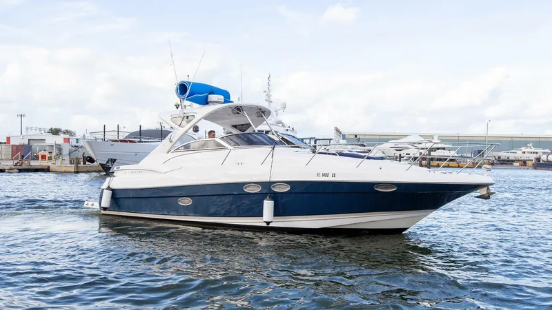 Slide: The Image of 2008 Regal 38 yacht cruising in a marina, featuring sleek design and blue accents. - 27